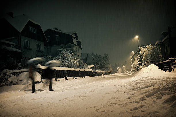 istock People going home on a snow stormy  night. 182426196