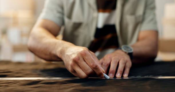 istock Closeup, hands and a tailor with clothes for measure, fitting or a design on fashion. Workshop, chalk line and designer, stylist or seamstress with manufacturing or production and creative on fabric 1824270065