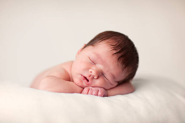 istock Newborn Baby Sleeping Peacefully on a Soft Blanket 182427226