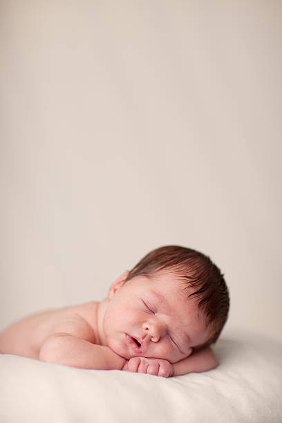 istock Newborn Baby Sleeping Peacefully on a Soft Blanket 182427230