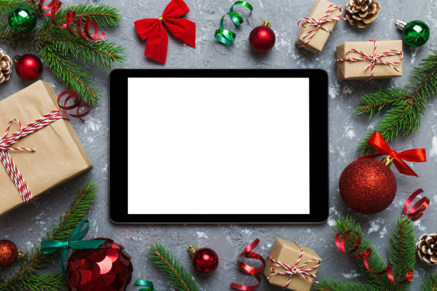 istock Digital tablet mock up with rustic Christmas decorations for app presentation top view with empty space for you design. Christmas online shopping concept. Tablet with copy space on colored background 1824272687