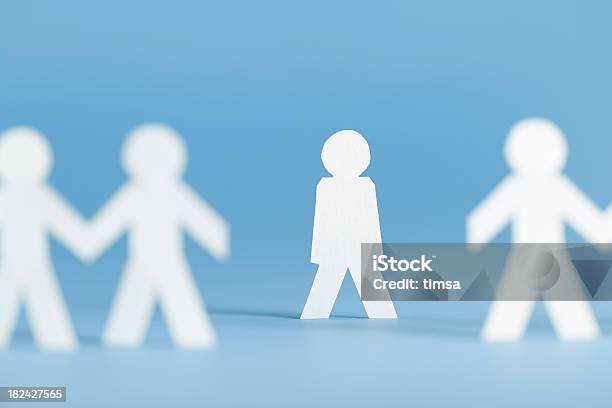 Paper Figures Holding Hands With One Alone Not Participating Stock Photo - Download Image Now