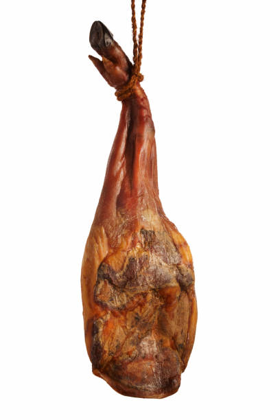 istock Delicious serrano ham hanging from a rope. Isolated on black. Gastronomy 1824279044
