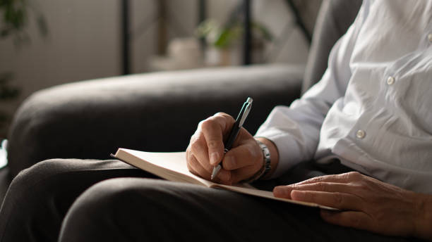 istock Close-up senior man writes diary at home 1824281128