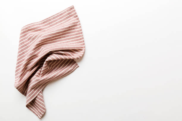 top view with red empty kitchen napkin isolated on table background. Folded cloth for mockup with copy space, Flat lay. Minimal style