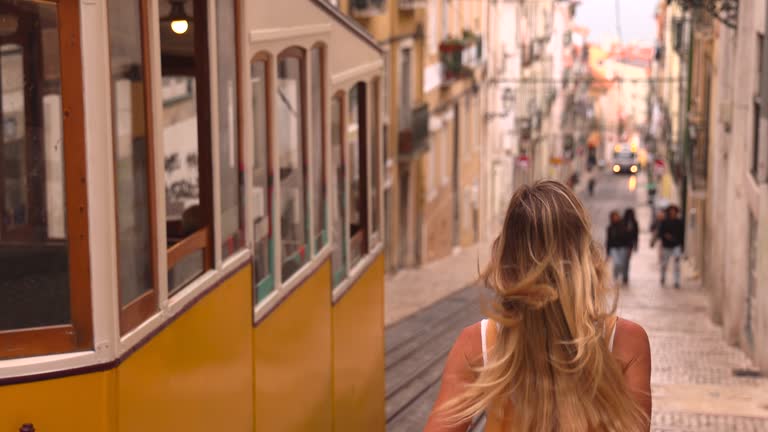 Slow Motion: Tourist walking the streets of Lisbon Portugal, Yellow cable car