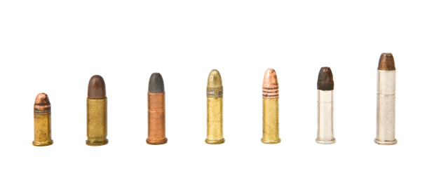 An assortment of small caliber rifle and handgun bullets isolated on a white background.