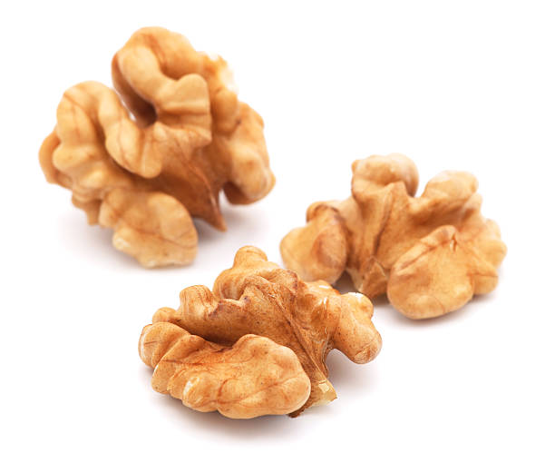 Close-up of three walnuts on a white background