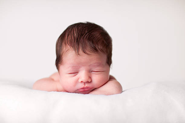 istock Newborn Baby Sleeping Peacefully on a Soft Blanket 182430242