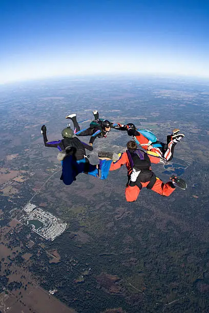 Photo of Royalty Free Stock Photo: Four Skydivers in Freefall Formation