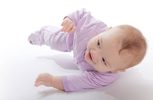 istock Baby in a purple jumper rolling around 182430344