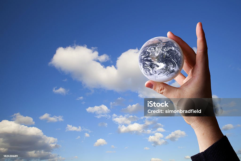 Global Environment Concept composite image of a hand holding up the Earth against a blue sky. Could refer to environmental concerns like climate change. Earth image courtesy of http://www.nasa.gov Africa Stock Photo