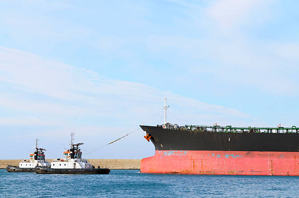 istock Oil tanker with two tug boats 182430717
