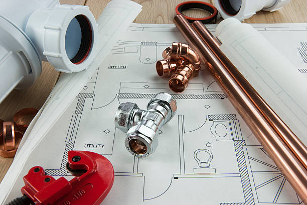 A plumbing diagram with copper pipe, tubing and fixings "An plumbing themed set with copper pipes, joints, plumbed service plans and tools (T-Joint is marked with a British/European Standard reference number and the size 15mm)" water pipe stock pictures, royalty-free photos & images