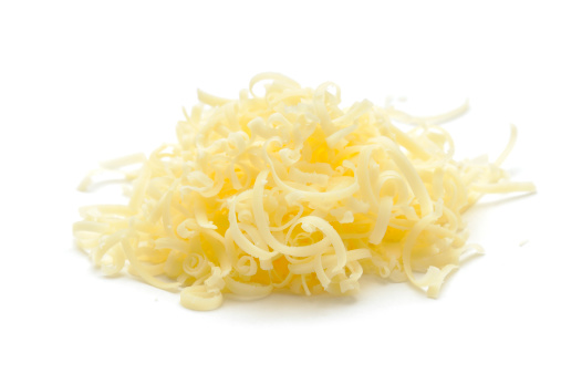 A small pile of grated Chedder isolated on a white background.