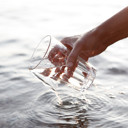 Filling glass with water.