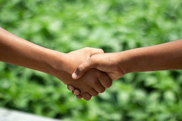 istock A man is shaking hands with another man and green background 1824317385