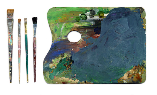 scanned image of painter's palette and old paint brushes. the palette has wonderful color and texture.