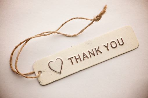 Old fashioned rustic tag features a heart and a Thank You message in white enamel on metal