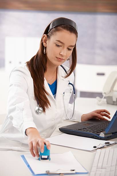 Portrait of young female doctor at office stock photo