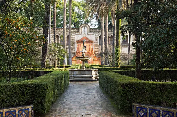 "The beautiful gardens of the Alcazar in Seville, Spain. The Alcazar, was originally a Royal Palace, and is one of the best remaining examples of Mudejar architecture. The upper levels of the palace which look out over the gardens, are still in use by the Royal Family when in residence ion Seville. The gardens are the largest late medieval gardens in Europe. ."