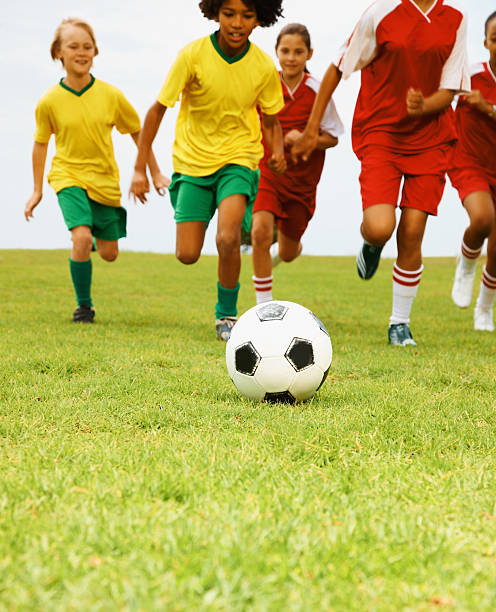 istock Children playing soccer in a stadium 182433572