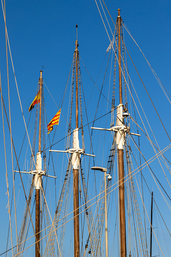 Marine signal flags set on a mast against of blue sky taken closeup.