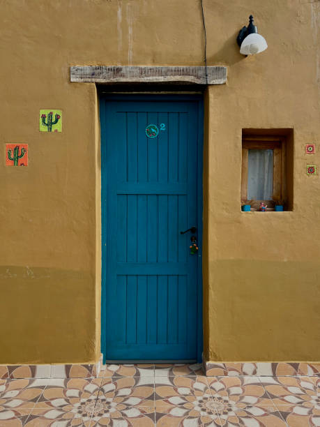 istock Turquoise door in ocher wall 1824343390