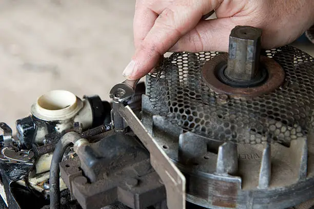 Man repairs a small gasoline engine... single cylinder... lawn mower...20081026085See more in my Small Engine Repair lightbox: