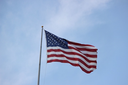 American flag against a dark and cloudy background