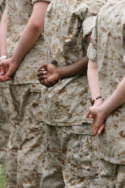 istock Three uniformed military members' backs are shown standing 182434514
