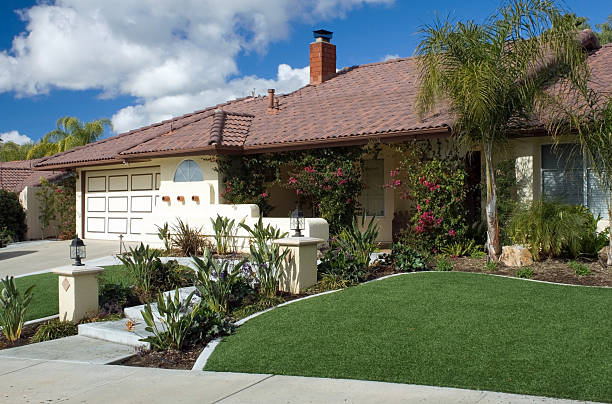 Artifical Lawn Home Horizontal Shot of tract home with artificial turf in front yard. artifical grass stock pictures, royalty-free photos & images