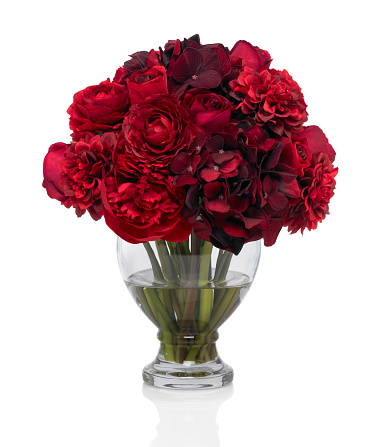 Close up of summer bouquet of pink roses dahlias flowers in vase on straw rattan wicker pad. Interior and decor at home. Space