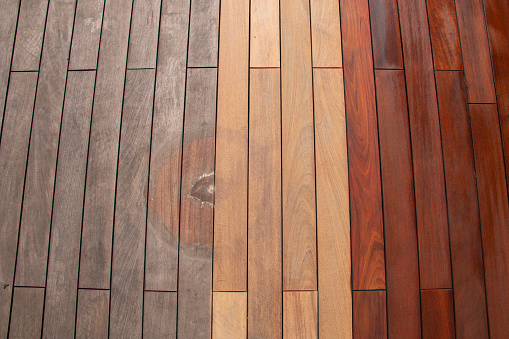 Wood planks texture - weathered with water stain of plant pot, sanded, and freshly oiled ipe deck