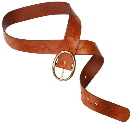 A crossed brown leather belt with a metal buckle on a white background is isolated. Place for advertisement, logo, label, mockup, mock-up.