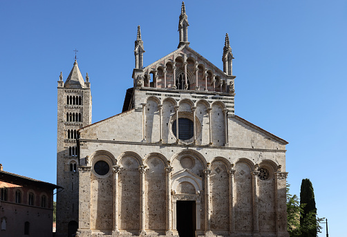 Massa Marittima, Italy - Sept 11, 2022: View at the Cathedral of Saint Cerbonius with Bell tower at the Garibaldi place in Massa Marittima. Italy