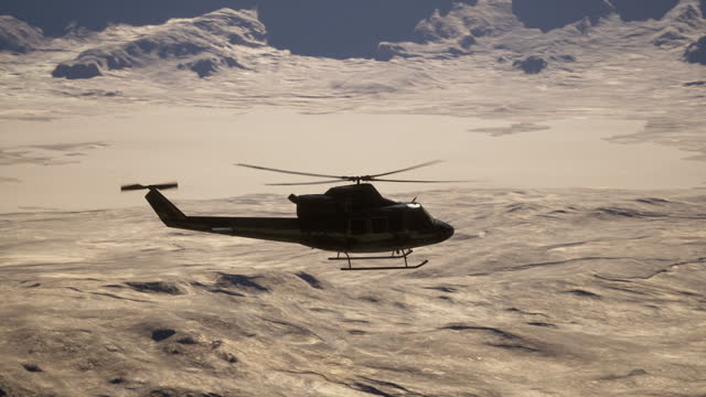 A helicopter flying over a snow covered mountain