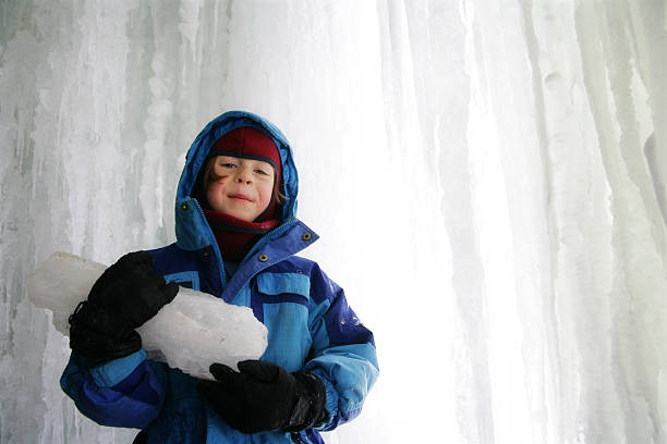 istock Little Boy Explores Behind a Frozen Waterfall 182435978