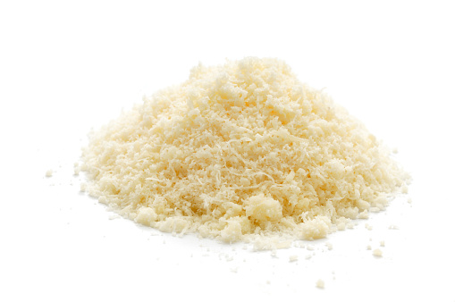 A small pile of grated parmesan cheese isolated on awhite background.
