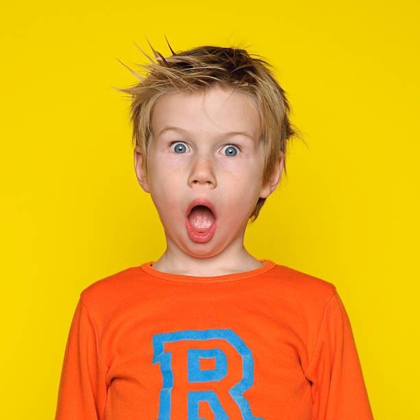 Surprised boy with his mouth open stock photo