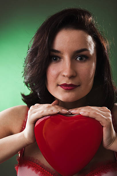 istock Girl with heart in her hand 182437200