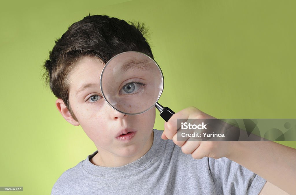 Magnifying Glass Boy looking through a magnifying glass. Magnifying Glass Stock Photo