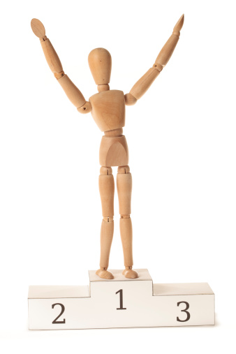 Wooden mannequin in a handmade paper podium celebrating his victory. This is an exclusive image and it can only be downloaded in istockphoto. This image is available in high resolution.Please see some similar pictures from my portfolio: