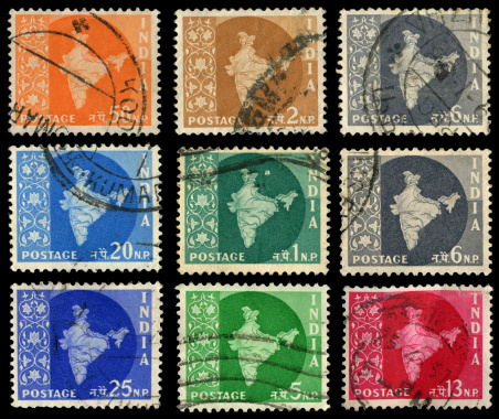 various Indian postage stamps on black