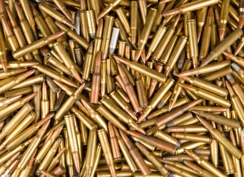 A large quantity of rifle and handgun shells well suited for a background.