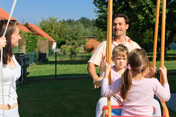 istock family playing in the garden 182438407