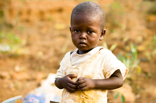 A little African boy standing alone.