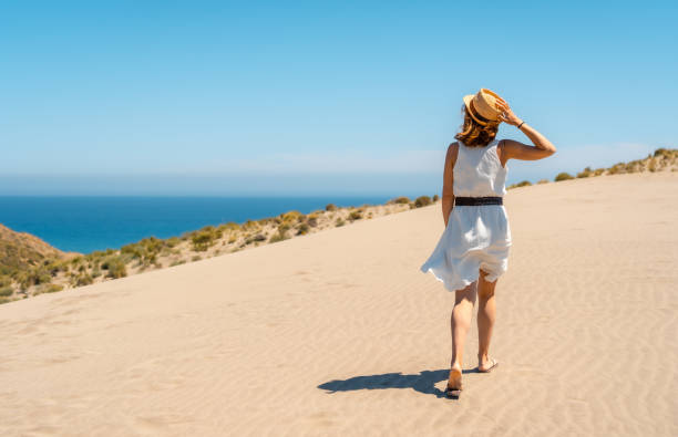 istock Woman strolling along a path with sea views 1824388080