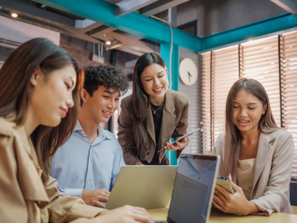 istock Working groups & Collaborations, Small group of young Asian people colleagues working together and discussing on new project at modern office 1824395894