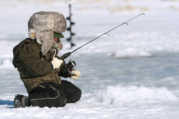 Ice Fishing Boy with his fishing pole ice fishing ice fishing stock pictures, royalty-free photos & images